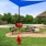 shaded benches in bark park with play equipment for pets