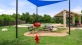 shaded benches in bark park with play equipment for pets