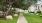 walkway leading to outdoor fire pit surrounded by beautiful landscaping