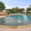 swimming pool with tanning shelf and fountains