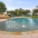 swimming pool with tanning shelf and fountains